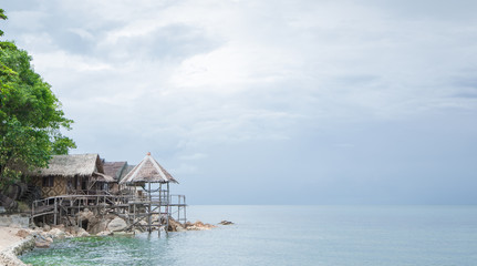 Naklejka premium View of nice bungalow on tropical empty sandy beach 