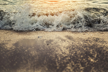 Soft and clean white wave of the sea on the sandy beach for summer nature background