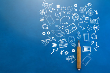 wooden pencil with businesss icon on blue leather background