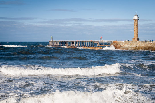 Whitby Light / Whitby Harbour West Pier with heavy seas comming in, Yorkshire, England.