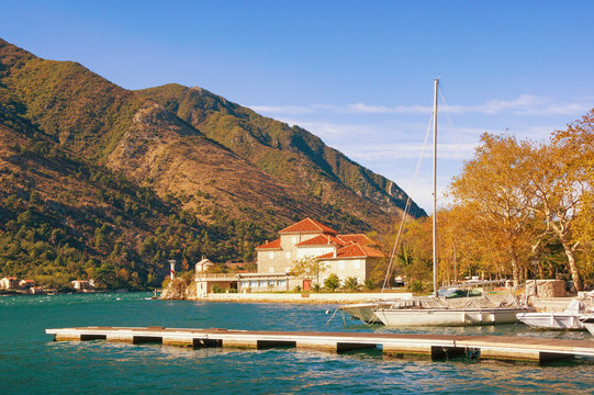 View of Mediterranean village of Dobrota (near Kotor city) on a sunny autumn day. Bay of Kotor, Montenegro