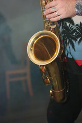 Musician playing on the saxophone at concert.