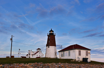Fototapeta na wymiar Point Judith Lighthouse after sunset at Narragansett RI, USA. The lighthouse is located on the west side of the entrance to Narragansett Bay.