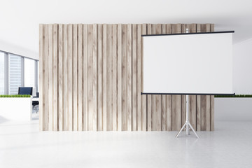 Whiteboard near a wooden office wall