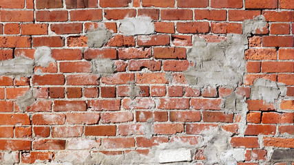 Poorly repaired and patched up brick wall

