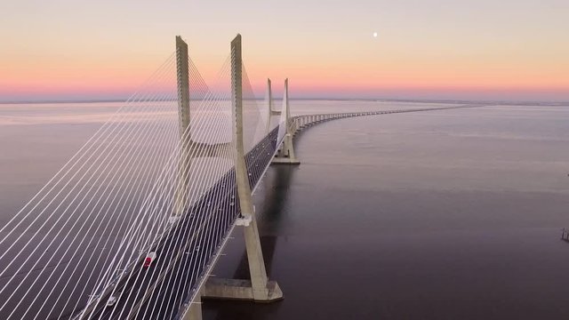 Vasco da Gama bridge over the Tagus river at sunset in Lisbon, Portugal, aerial view.