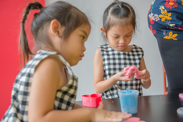 Little girl molding colorful clay for some products,think from imagination,happy kids play concept