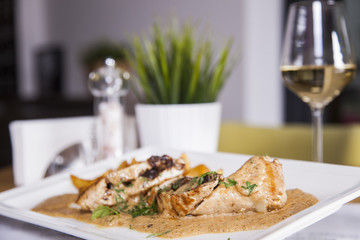 Baked chicken breast stuffed with cheese and spinach, close-up on a plate.isolated
