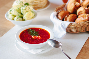 Beautiful russian national soup - borscht at white plate.