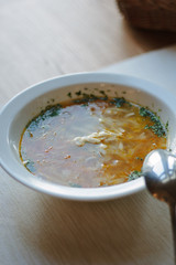 Nice and hot soup at the white ceramic plate at the restaurant.