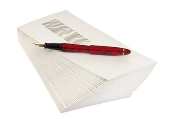 stack of mail envelopes and a pen