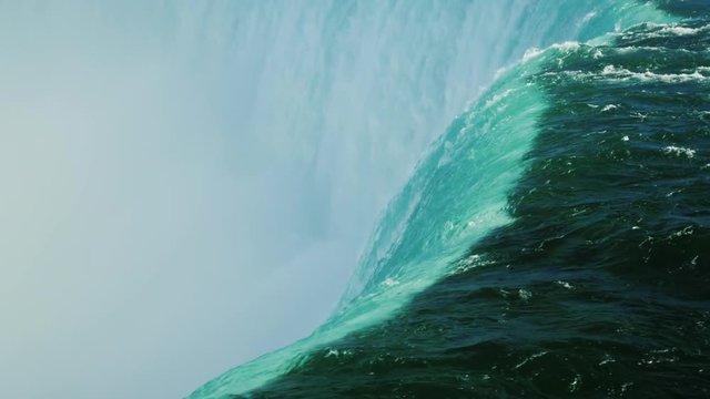 Water falls into the abyss, the Horseshoe falls on the Niagara River. Element Power Concept. Slow motion video