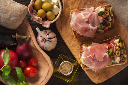 Bruschetta with vegetables and ham, italian style cuisine.