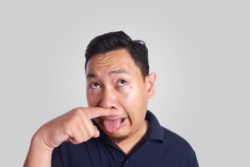 Asian Man Close His Nose Sick of Bad Smell