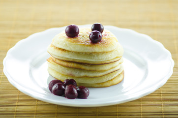 Pancakes with cherries on top