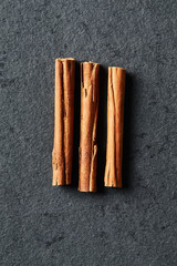 Cinnamon Sticks on stone background; close up