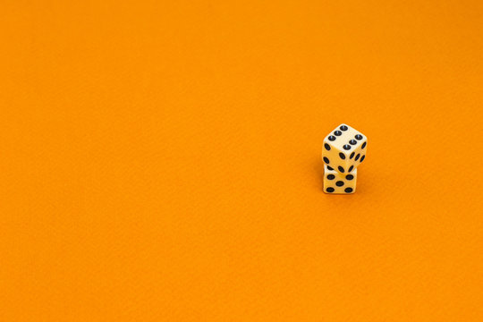 Isolated white dice on a orange background