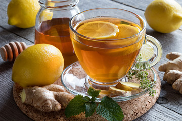 A cup of tea with ginger root, lemon, melissa and honey - obrazy, fototapety, plakaty