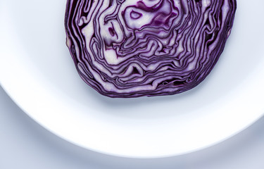 Obraz premium Cut of red cabbage on the white plate