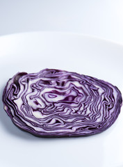 Obraz premium Cut of red cabbage on the white plate