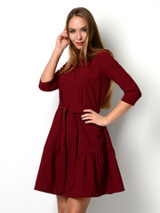 Young beautiful woman posing in new fashion red pattern winter dress