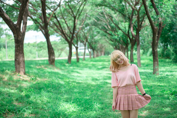 Portrait of asian young girl at tunnel trees,Beautiful thai woman take a photo outdoors,happy woman concept,she feeling fresh air