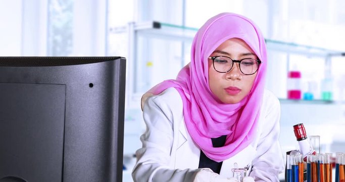 Young scientist doing experiment while mixing chemical fluid in the laboratory room. Shot in 4k resolution