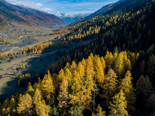 Aerial view of mountain valley in Switzerland. Fall colors during indian summer