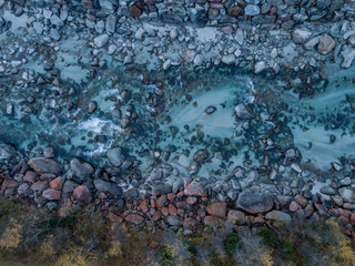 Aerial view of river flowing between rocks, close up