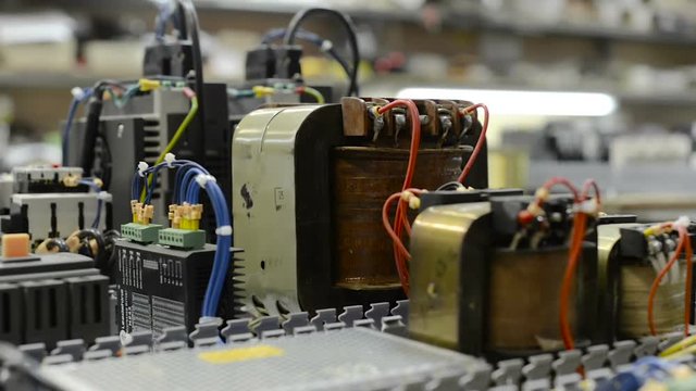Electrical modules, switches, relays and cables are mounted on the circuit board.