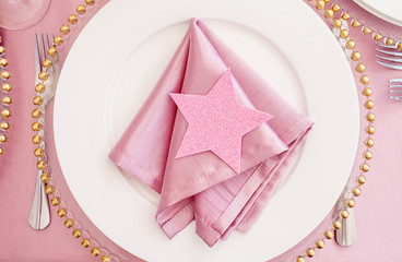 Served plate with pink napkin and decorative shiny star