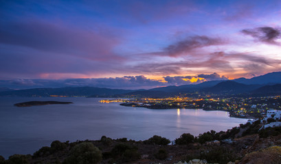 Panoramic high point view at sunset of the picturesque gulf of Mirambello, with the island of Agioi Pantes and the town of Agios Nikolaos, Crete, Greece