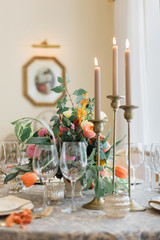 a dining table and comfortable armchairs in a modern house with a light dining room