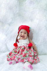 Portrait of cute asian baby in pink dress on carpet wool,happy baby concept,smile,thail little baby