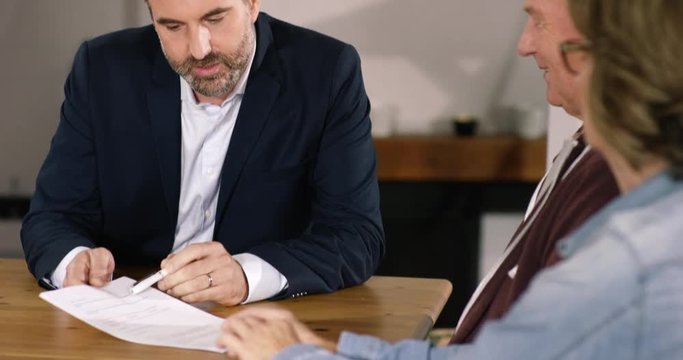 Salesman explaining forms to senior couple