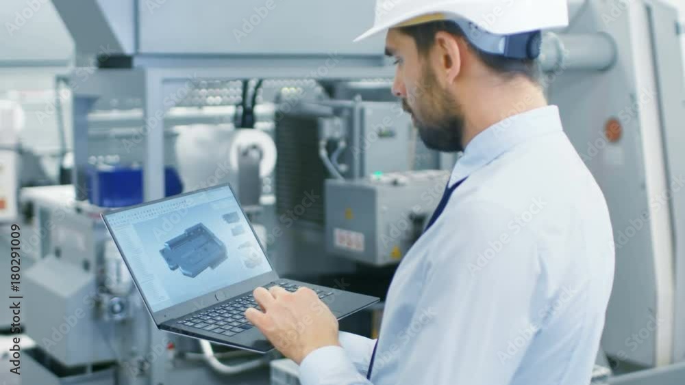 Poster chief engineer in the hard hat holds laptop with 3d component model on it's screen. in the backgroun