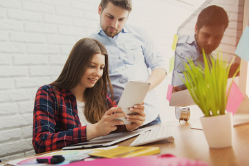 Team of creative designers working on a common project in a design studio