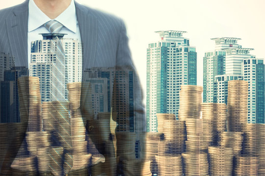 Double exposure of businessman over the money coins in the big city