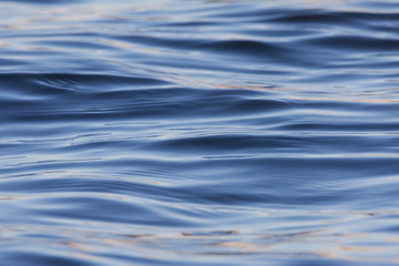 Water waves and ripples. Blue dark and shine.
