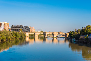 Fototapeta na wymiar Bridge over the Ebro River, Zaragoza, Spain. Copy space for text.