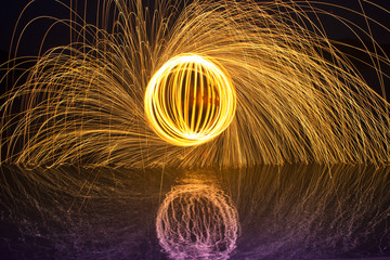 Light painting / light drawing with fire and steel wool  on the lake