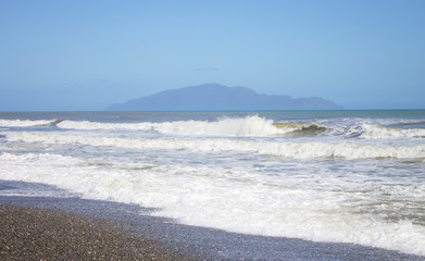 Kapiti Island viewed from Otaki Beach on the Kapiti Coast of New Zealand.