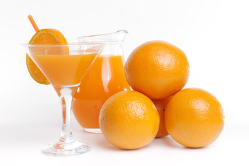 Glass jar and glass with orange juice.