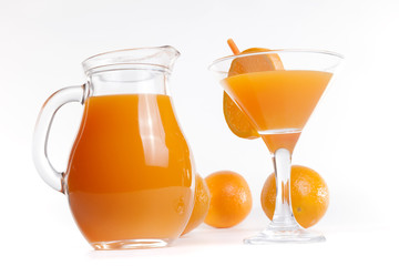 Glass jar and glass with orange juice.