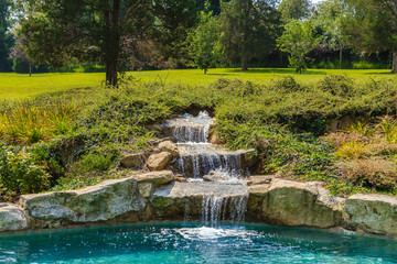Fototapeta na wymiar Rock Waterfall in Pool