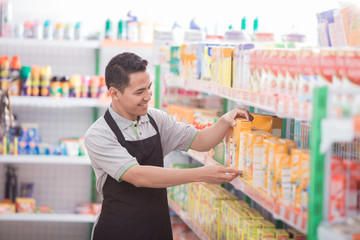 male shopkeeper working in a grocery store