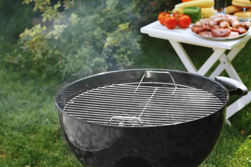 Barbecue grill with smoke on backyard © Africa Studio