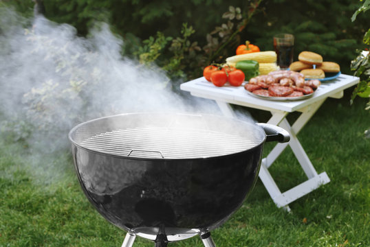 Barbecue grill with smoke on backyard