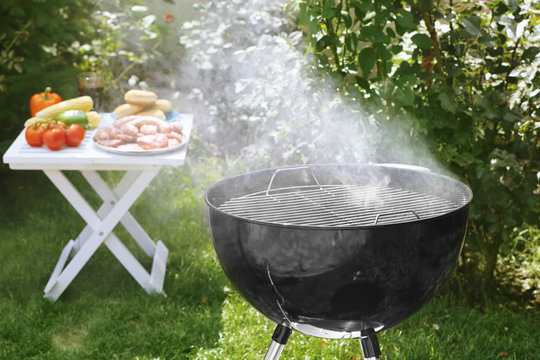 Barbecue grill with smoke on backyard