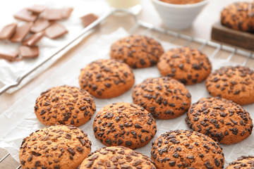Cooling rack with chocolate chip oatmeal cookies on table, closeup